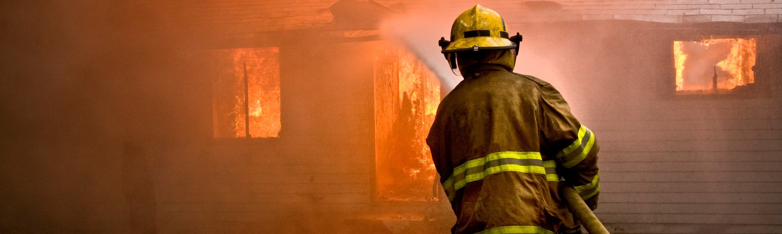 fireman hosing burning building